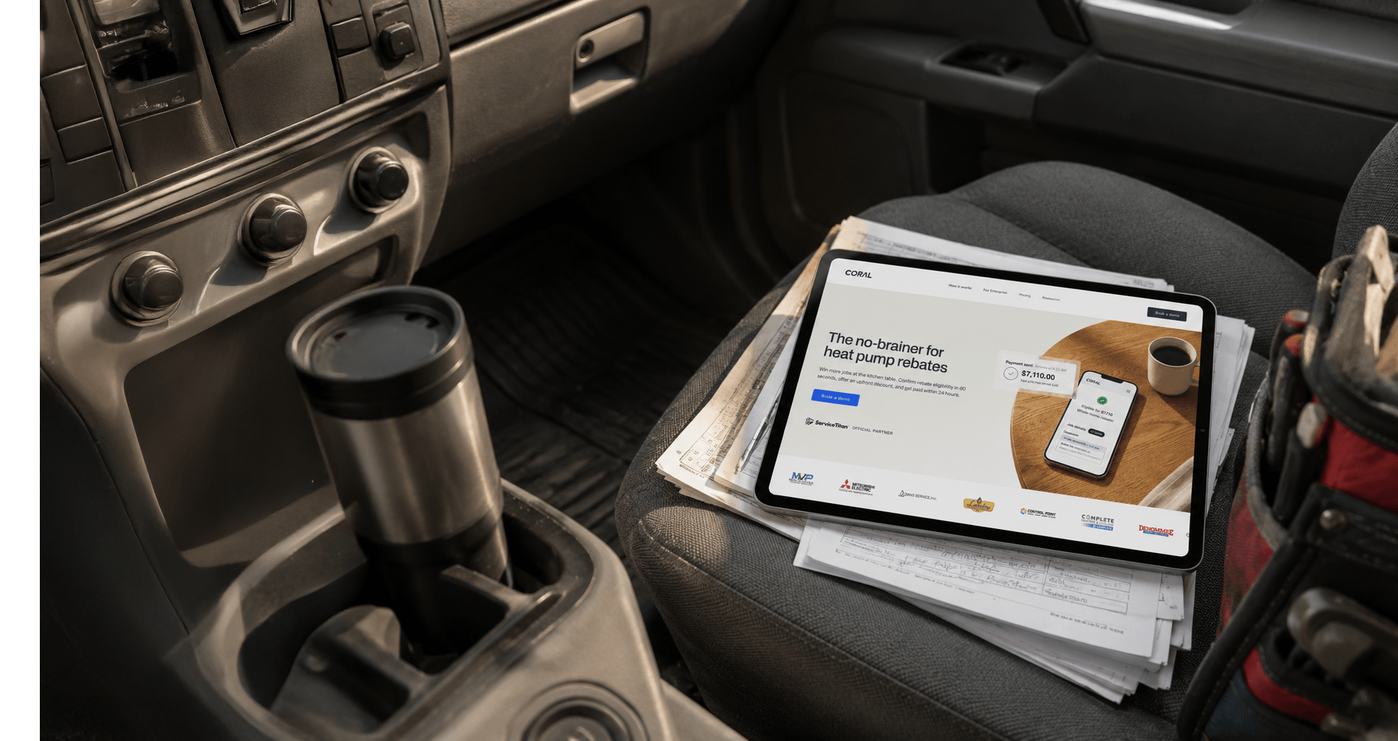 A contractor viewing Coral on a tablet in a service vehicle