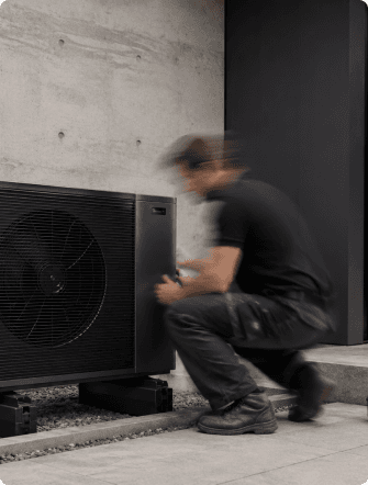 A technician installing a heat-pump system