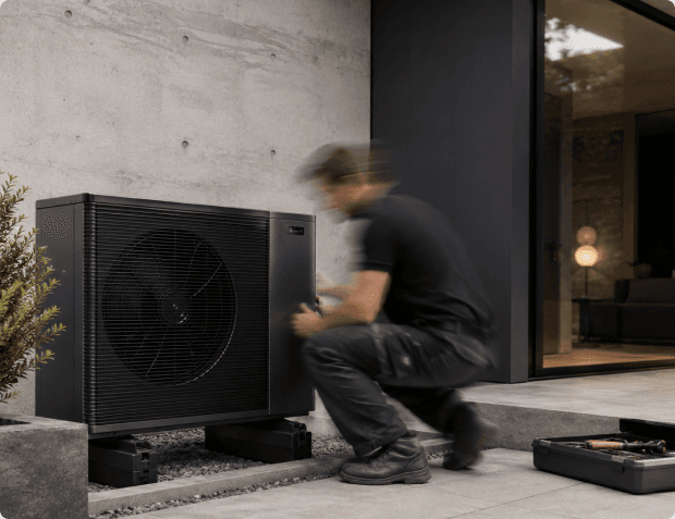 A technician installing a heat-pump system