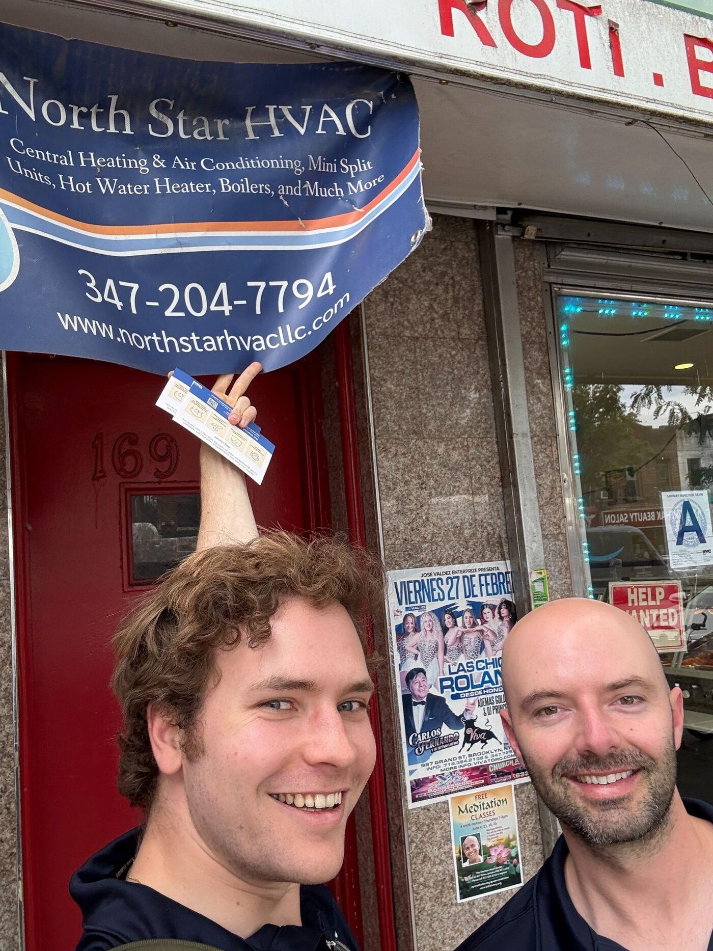 Two Coral team members taking a selfie outside an HVAC contractor's office in Brooklyn