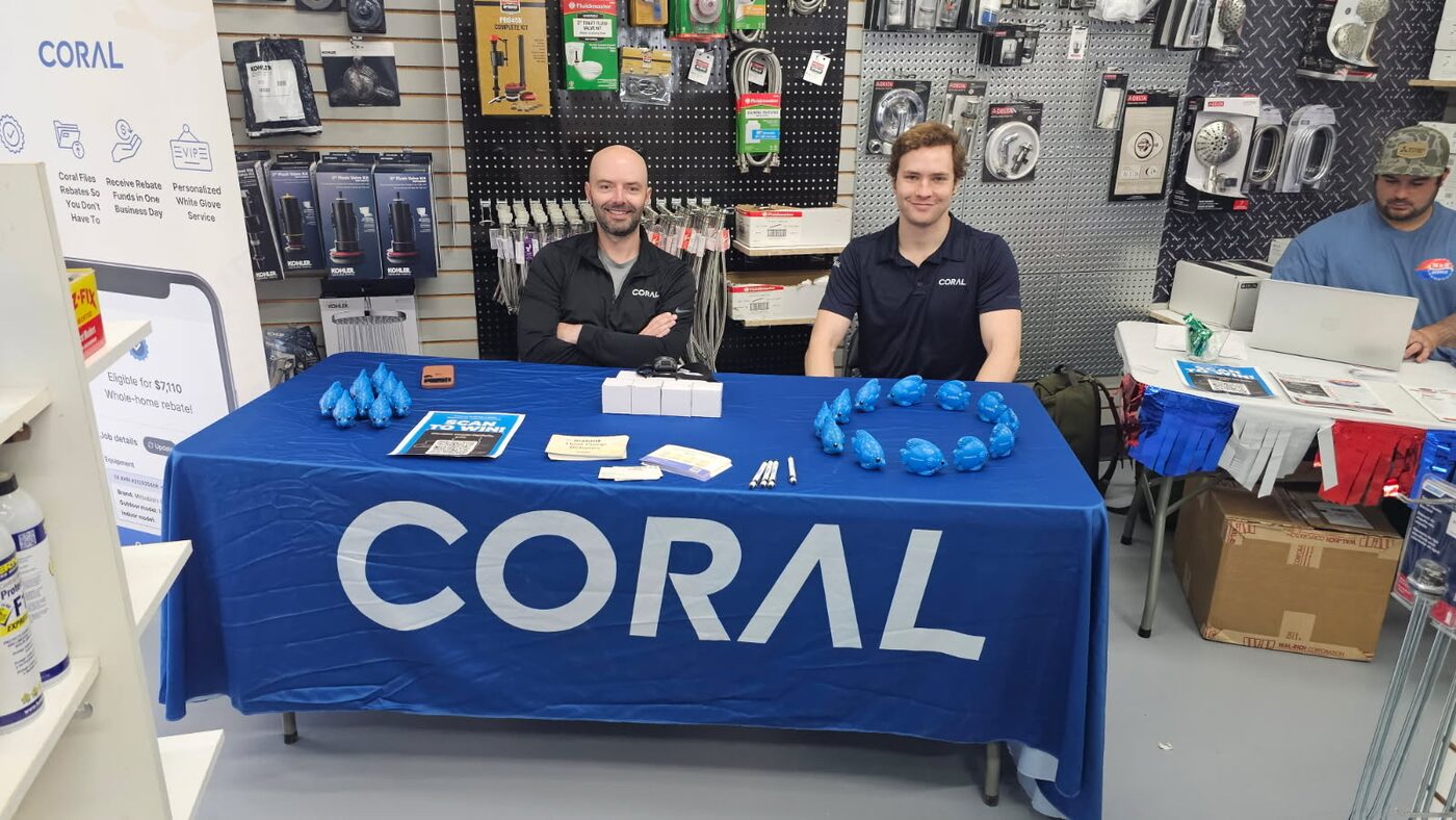 Two Coral team members at a company booth inside a hardware store in Saratoga